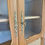 Miniature : Vitrine ancienne en bois clair, portes vitrées et cannage