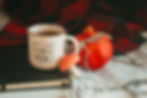 Pomegranate tea in a mug next to the fruit