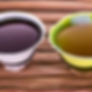 Cartoon green tea vs. herbal tea in small mugs on a wood table