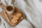 A mug of honeybush chai next to some cookies
