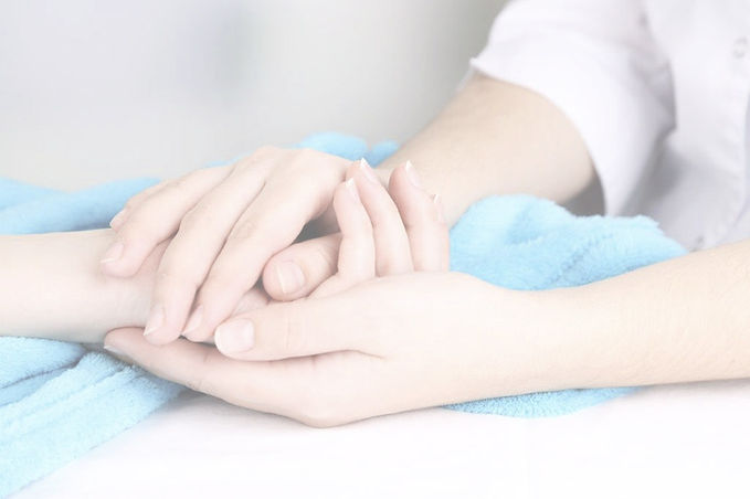caregiver offering comforting hand hold