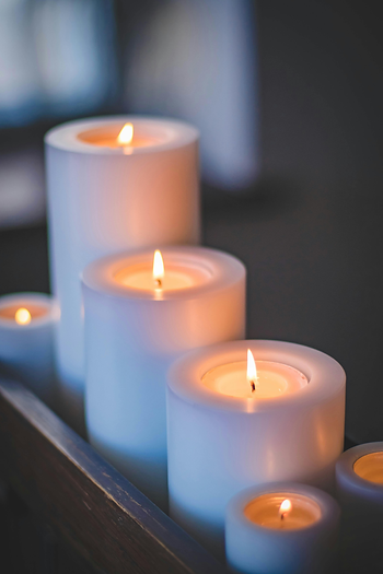Spa candles glowing in a dimly lit massage room
