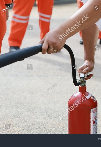 stock-photo-employees-firefighting-training-concept-employees-hand-using-fire-extinguisher