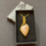 tumblestone pendant wrapped in gold in gift box