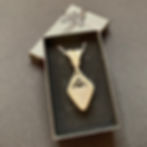 triangular tumblestone wrapped in silver wire in gift box
