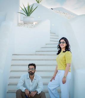 Couple on white steps during a relaxed couple photoshoot