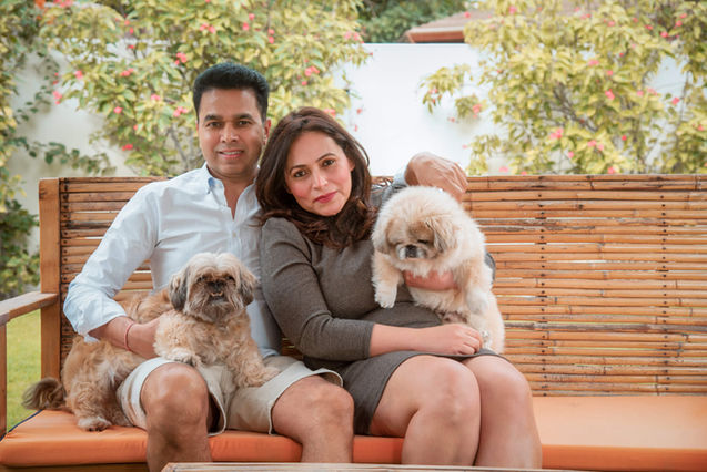 Couple with their two dogs on a garden bench