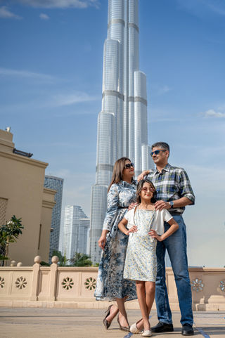 Indian family of three visiting Dubai, the Burj Khalifa behind them