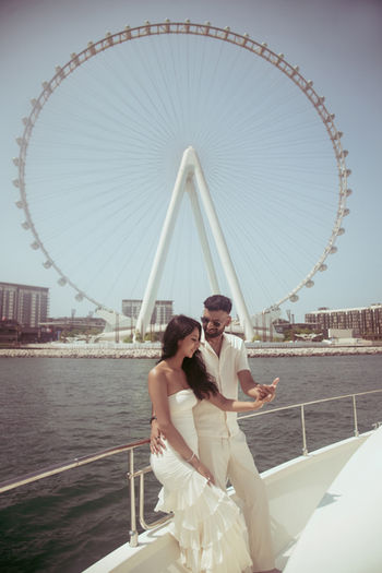 Couple on a yacht with Ain Dubai behind