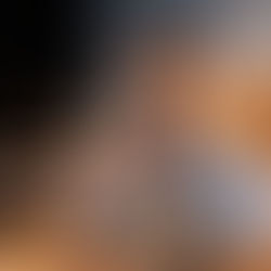 Eye-level view of a solopreneur smiling and packing products.