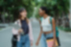 2 bestfriends on campus walking and chatting