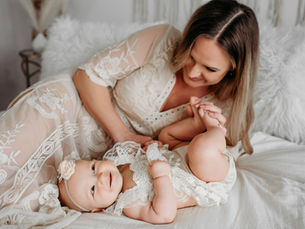 Boise motherhood photography session capturing a mother holding her child in natural light