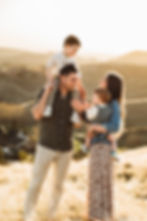 young family standing atop Boise, Idaho foothills during family portrait session