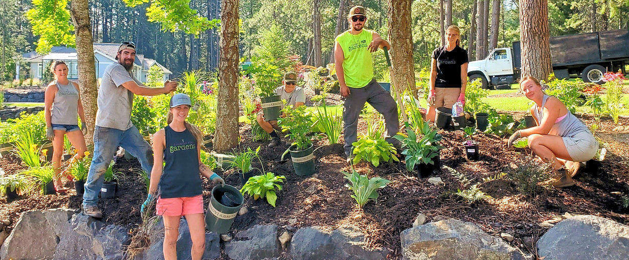 Country Girl Gardens landscaping crew planting a flowerbed