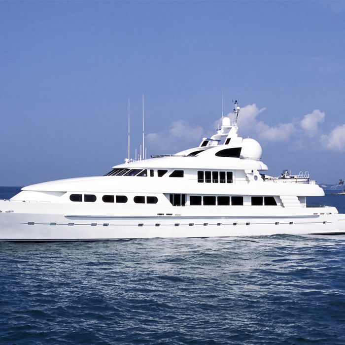 Large white luxury yacht cruising across the blue ocean