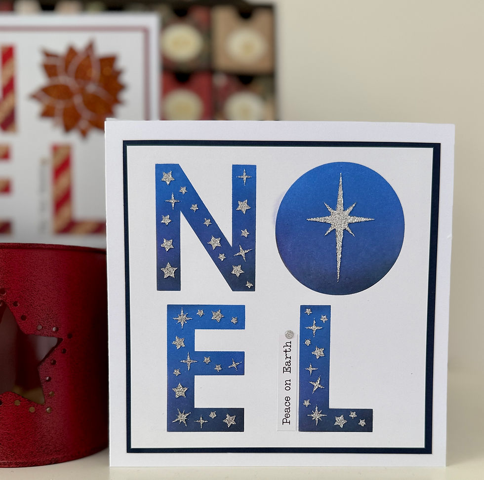 White card with blue starry NOEL, starburst O, and Peace on Earth