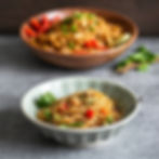 Bowl of spaghetti with vegetables and herbs
