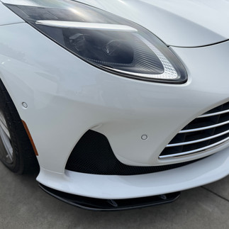 Close up of white Aston Martin DB12 bumper after ceramic ppf install at our shop in Napa