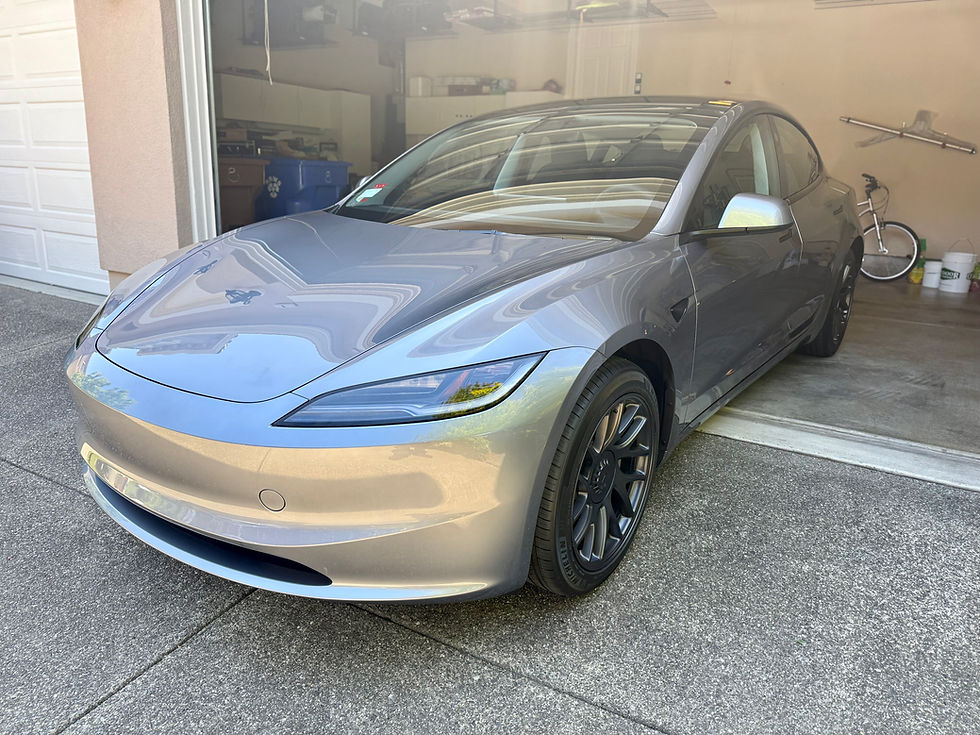 De-badged and coated silver Tesla Model 3 inside customer’s garage with mobile coating installation