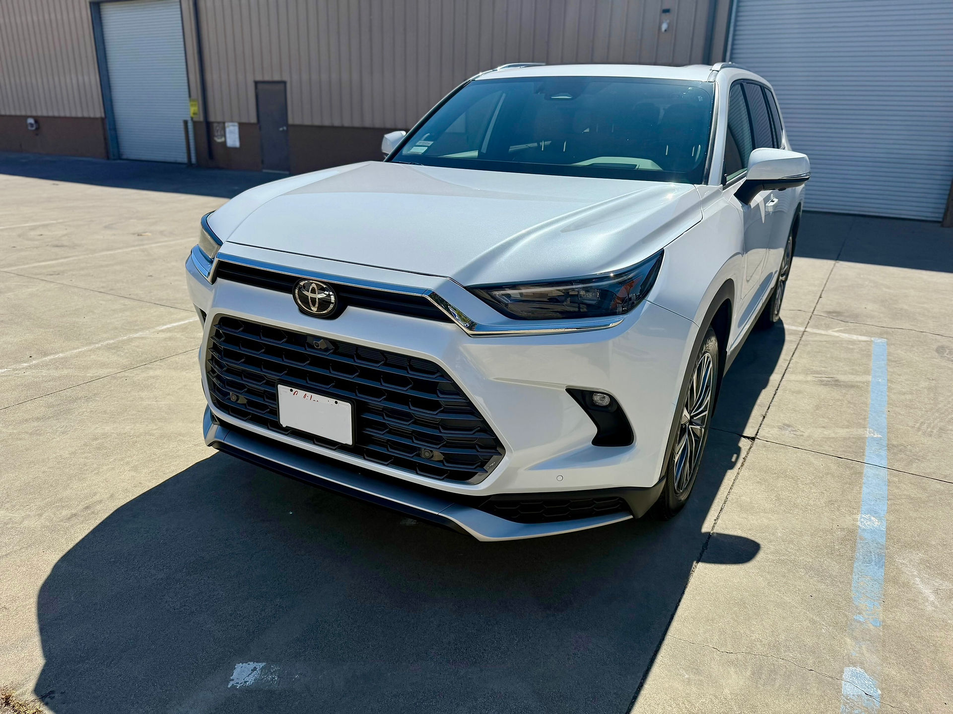 Front side view of coated Toyota Grand Highlander outside Robust Paint Protection & Auto Detailing shop in Napa, by a Sonoma Customer