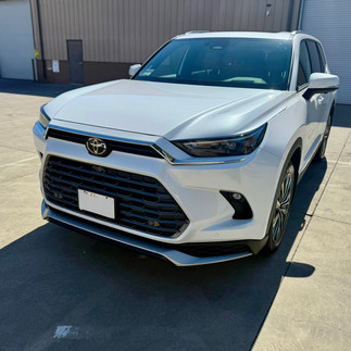 Front side view of coated Toyota Grand Highlander outside Robust Paint Protection & Auto Detailing shop in Napa, by a Sonoma Customer