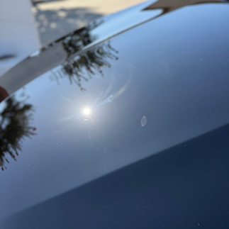 Black Mercedes GLC outside our shop after paint correction and ceramic coating Showing swirls gone on the hood in direct sunlight