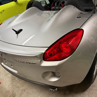 Back view of Pontiac Solstice after two-step paint correction and graphene coating installation done by Robust Paint Protection & Mobile Detailing inside Gilroy, California, inside a customer’s garage