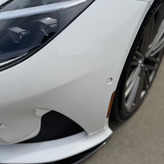 Close up of ceramic paint protection film on bumper of Aston Martin DB12