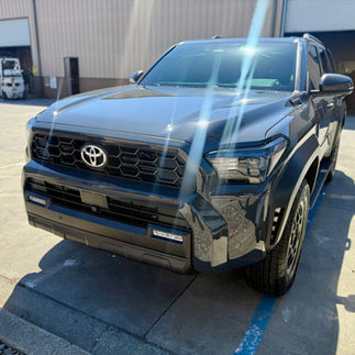 Driver side hood view of bulk cut Ceramic Paint Protection Film (PPF) and Ceramic Coating on Grey Toyota 4Runner in Napa outside our Robust shop