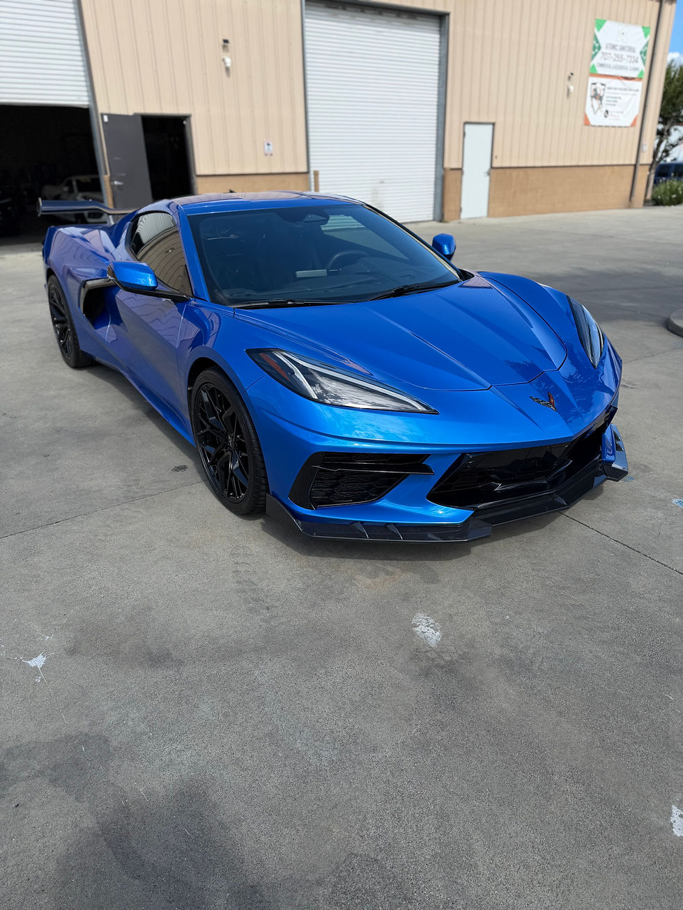 Blue C8 Corvette with full front and side skirt PPF wrap outside our Napa Shop