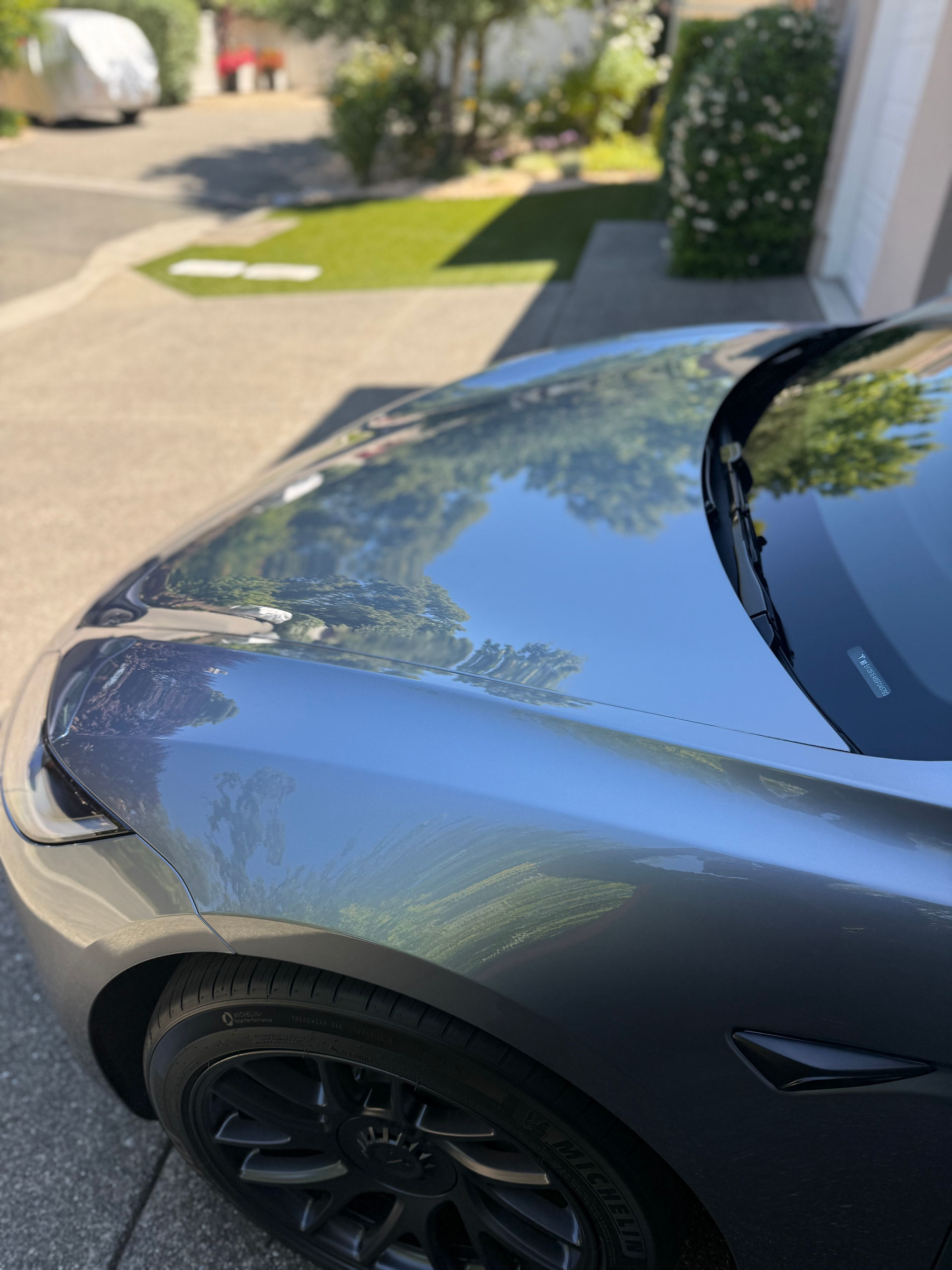 Top Hood view of ceramic coated Tesla Model 3 in customer’s garage in Napa installed by Robust Paint Protection & Auto Detailing, silver color vehicle
