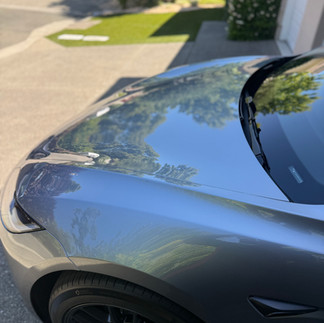 Top Hood view of ceramic coated Tesla Model 3 in customer’s garage in Napa installed by Robust Paint Protection & Auto Detailing, silver color vehicle