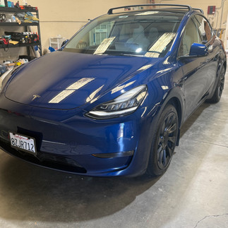 Front view after two-step paint correction on blue Tesla Model Y at our detail and coating shop in Napa
