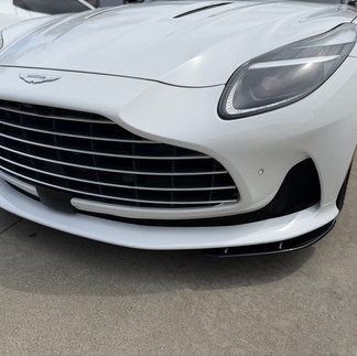 Full bumper view of white Aston Martin DB12 with ceramic paint protection film PPF at our shop