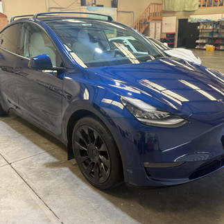 Front side view after two-step paint correction on blue Tesla Model Y at Robust Shop in Napa