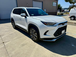 Front side view of Toyota Grand Highlander outside Robust Paint Protection & Auto Detailing shop in Napa, California