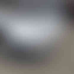 Front bumper showing clear ceramic paint protection film PPF on white Aston Martin DB12 in Napa