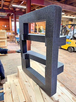 Charcoal foam insert frame held up for fitting in the McConnell shop