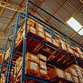 Corrugated shipping boxes on wood pallets in warehouse racking