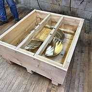 Wood crate with internal blocking and bracing holding metal parts