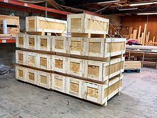 Plywood crates stacked on skids, ready for delivery