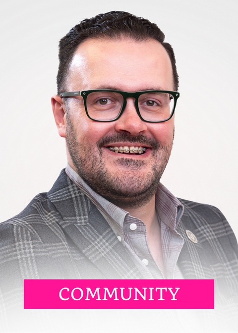 Josh smiles in a headshot with the word COMMUNITY in upper case is centered in a pink rectangle at the bottom center of the frame