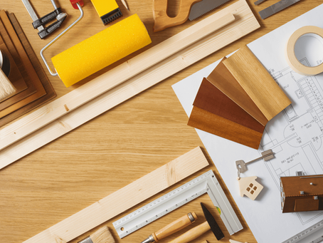 Construction planning flat lay with floorplans, swatches, and tools—representing full-scope remodeling and building services in Victoria, TX