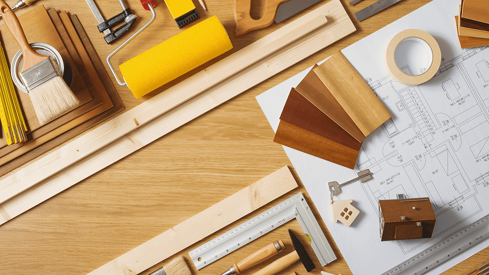 Construction planning flat lay with floorplans, swatches, and tools—representing full-scope remodeling and building services in Victoria, TX