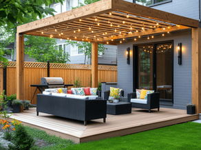 Custom outdoor spaces in Victoria, TX featuring a wood pergola with string lights, deck, and patio seating