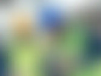 Two local construction workers in safety gear reviewing blueprints and project plans on a job site in South Texas, showcasing hands-on planning and expertise.