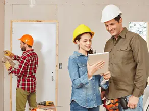 Contractors reviewing renovation plans on-site during a commercial remodeling project in Victoria, TX