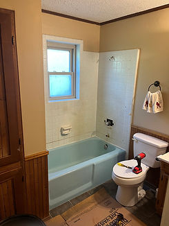 Bathroom before renovation with an old bathtub and fixtures. A before image of our construction projects in Victoria, Texas by Framing to Finish.