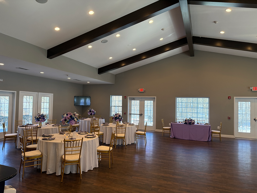 Baby shower decor in maryland, purple table cloths with gold charvari chairs 
