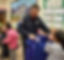 Firefighter delivering winter coats to children